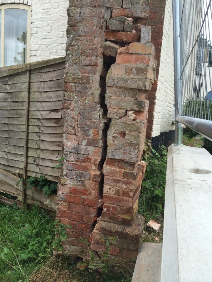 A dangerously crumbling gate pillar